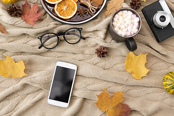 Image showing smartphone, hot chocolate and autumn leaves