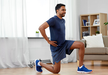 Image showing indian man exercising and doing squats at home