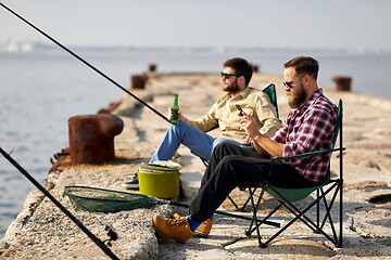 Image showing friends with smartphone and beer fishing on pier
