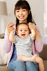 Image showing happy young mother with little baby son at home