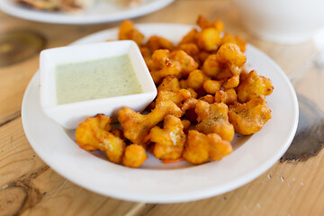 Image showing close up of cauliflower pakora with dip sauce