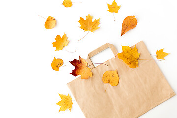 Image showing autumn leaves and paper bag on white background