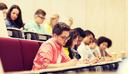 Image showing group of students with notebooks in lecture hall