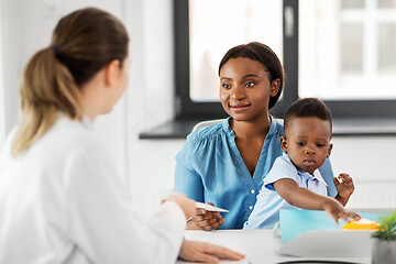 Image showing happy mother with baby son and doctor at clinic