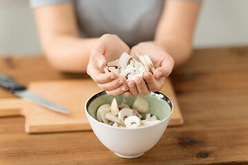 Image showing close up of woman holding chopped champignons