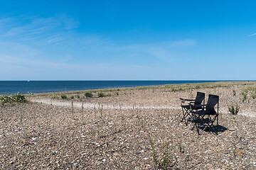 Image showing Summer view with two empty chairs by the coast