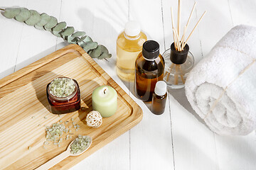 Image showing Beautiful spa composition on massage table in wellness center, copyspace, leaves\' shadow