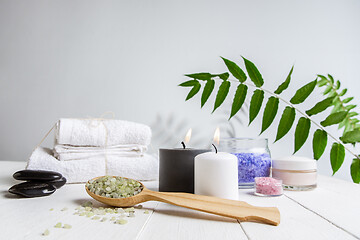 Image showing Beautiful spa composition on massage table in wellness center, copyspace, green leaf