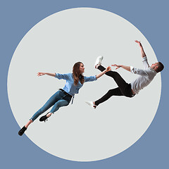 Image showing Mid-air beauty. Full length studio shot of attractive young woman and man hovering in air and keeping eyes closed