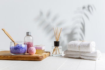 Image showing Beautiful spa composition on massage table in wellness center, copyspace, leaves\' shadow