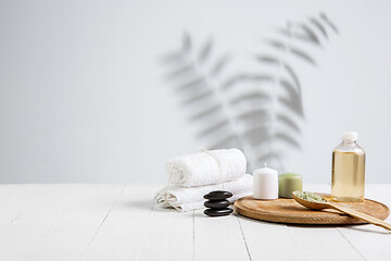 Image showing Beautiful spa composition on massage table in wellness center, copyspace