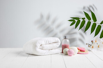 Image showing Beautiful spa composition on massage table in wellness center, copyspace. Leaves\' shadows on the wall