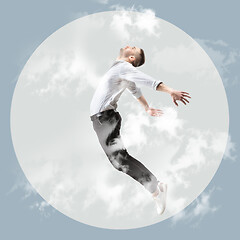 Image showing Mid-air beauty. Full length studio shot of attractive young man hovering in air and keeping eyes closed