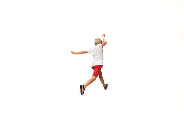 Image showing Happy little caucasian boy jumping and running isolated on white background