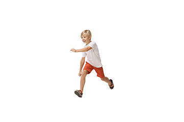 Image showing Happy little caucasian boy jumping and running isolated on white background