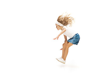 Image showing Happy little caucasian girl jumping and running isolated on white background