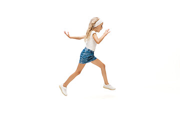 Image showing Happy little caucasian girl jumping and running isolated on white background