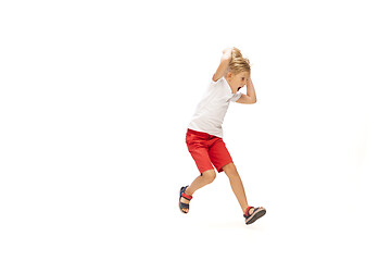 Image showing Happy little caucasian boy jumping and running isolated on white background