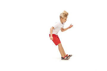 Image showing Happy little caucasian boy jumping and running isolated on white background