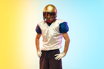 Image showing American football player isolated on gradient studio background in neon light