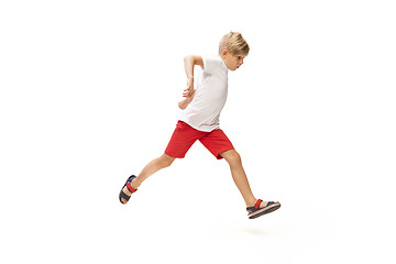 Image showing Happy little caucasian boy jumping and running isolated on white background