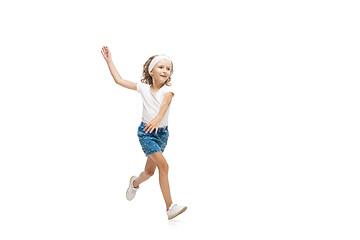 Image showing Happy little caucasian girl jumping and running isolated on white background