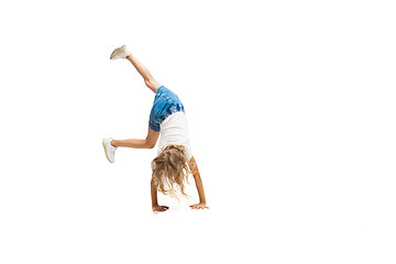 Image showing Happy little caucasian girl jumping and running isolated on white background