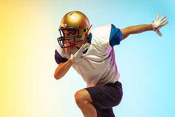 Image showing American football player isolated on gradient studio background in neon light