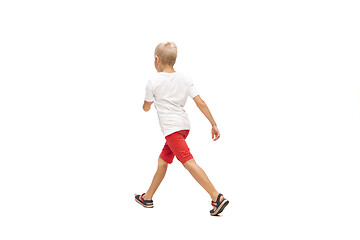 Image showing Happy little caucasian boy jumping and running isolated on white background