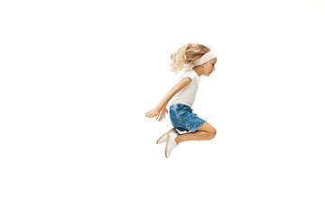 Image showing Happy little caucasian girl jumping and running isolated on white background