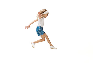 Image showing Happy little caucasian girl jumping and running isolated on white background