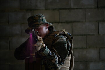 Image showing soldier in action aiming  on laser sight optics