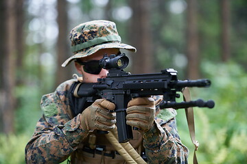 Image showing soldier in action aiming  on weapon  laser sight optics