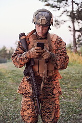 Image showing soldier using smart phone