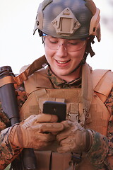 Image showing soldier using smart phone
