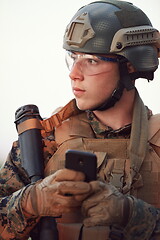 Image showing soldier using smart phone