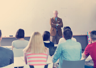 Image showing teacher with a group of students in classroom