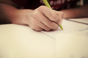 Image showing student hand underlining a document