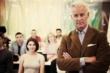 Image showing portrait of  teacher with students group in background