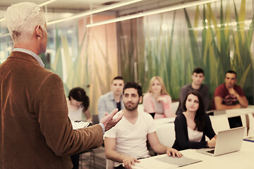 Image showing teacher with a group of students in classroom