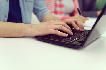 Image showing close up of student hands typing on laptop