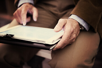 Image showing Closeup of mature hands holding tablet.