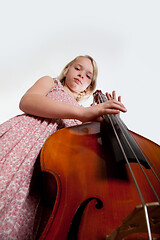 Image showing Portrait of a young teenager girl in studio with a cello