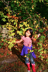 Image showing Portrait of a young cute girl looking at the camera outdoor