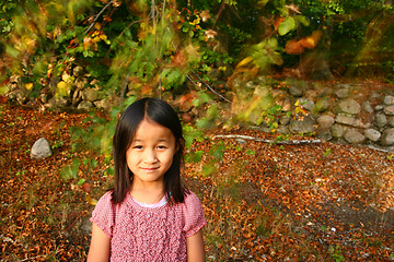 Image showing Portrait of a young cute girl looking at the camera outdoor