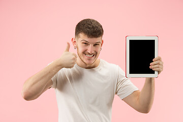 Image showing portrait of smiling man pointing at laptop with blank screen isolated on white