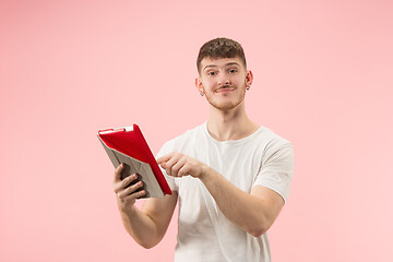 Image showing portrait of smiling man pointing at laptop with blank screen isolated on white