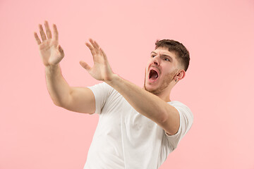 Image showing Portrait of the scared man on pink