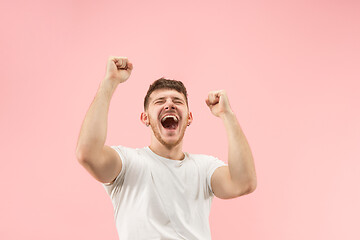 Image showing Winning success man happy ecstatic celebrating being a winner. Dynamic energetic image of male model