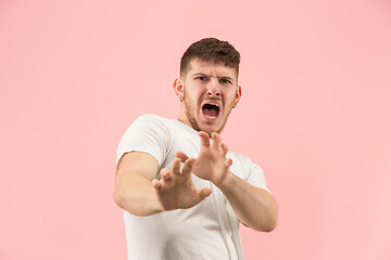 Image showing Portrait of the scared man on pink